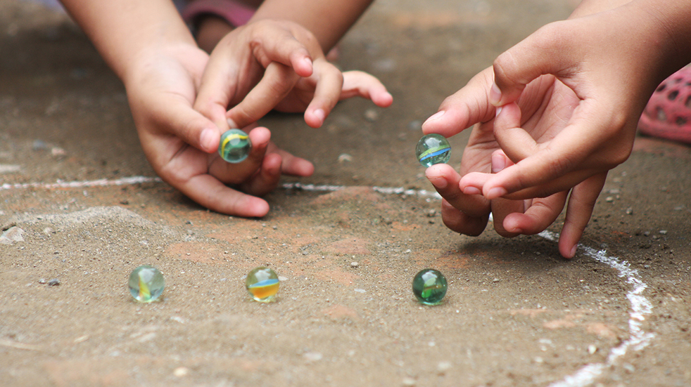 Cheap ideas to entertain kids - play old school game of marbles